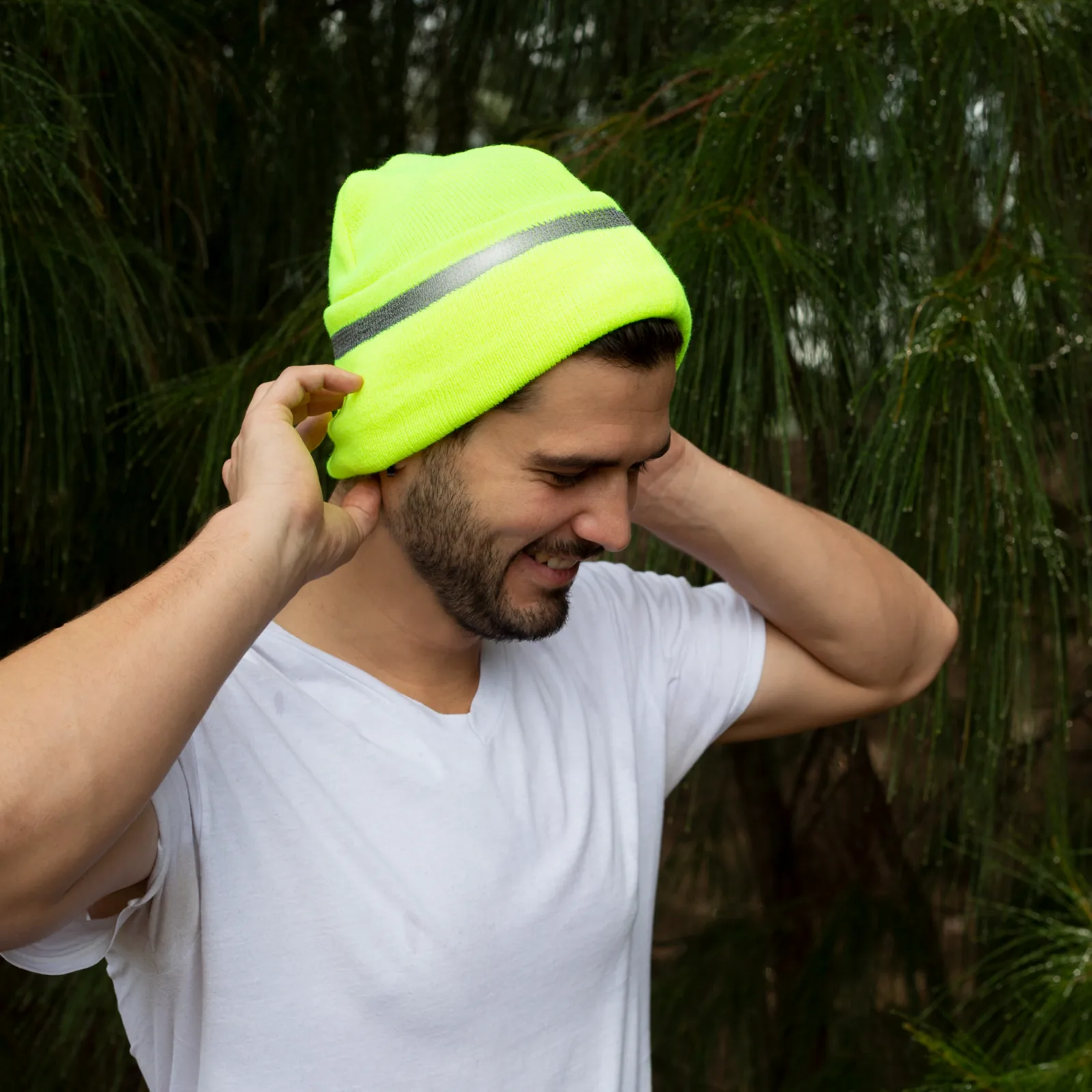 Un hombre usando el gorro beanie de seguridad JORESTECH color lima de alta visibilidad para aumentar la visibilidad